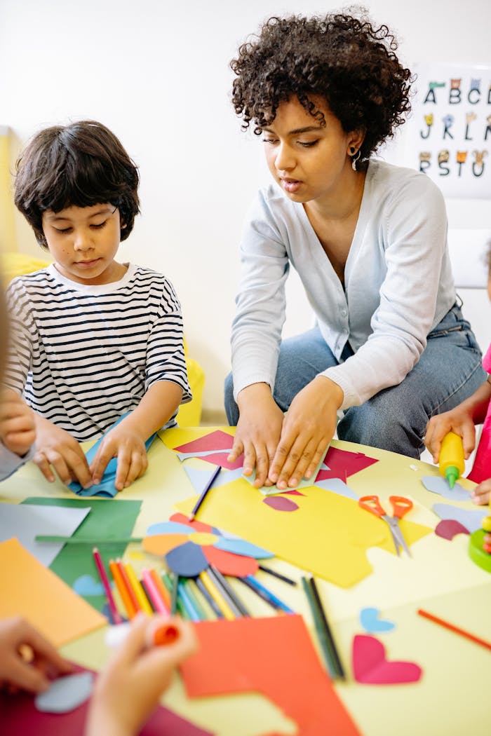 Children and teacher engaging in creative arts and crafts activities indoors.