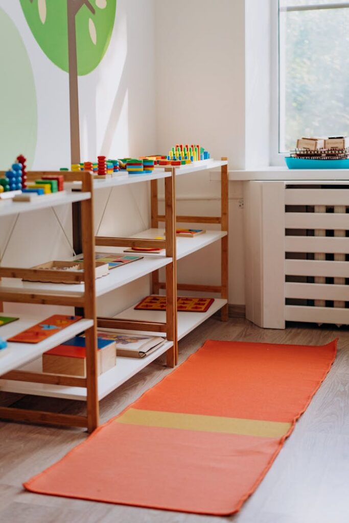 Colorful educational toys neatly arranged on shelves in a well-lit kindergarten classroom.